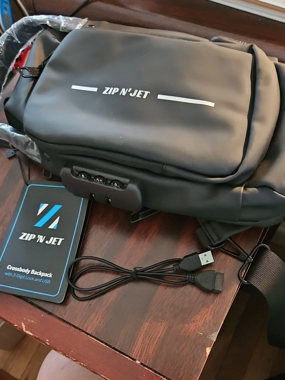 Black Crossbody Travel Backpack with USB & 3-Digit Lock